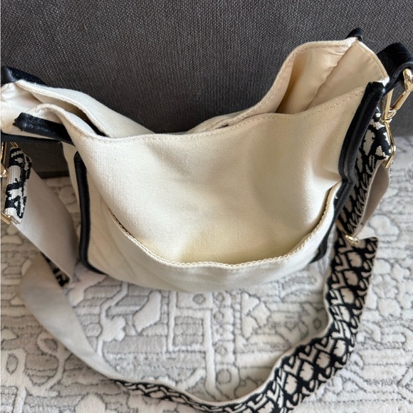 Adorned Beautiful cream purse/crossbody with fun black strap. - Picture 2 of 11